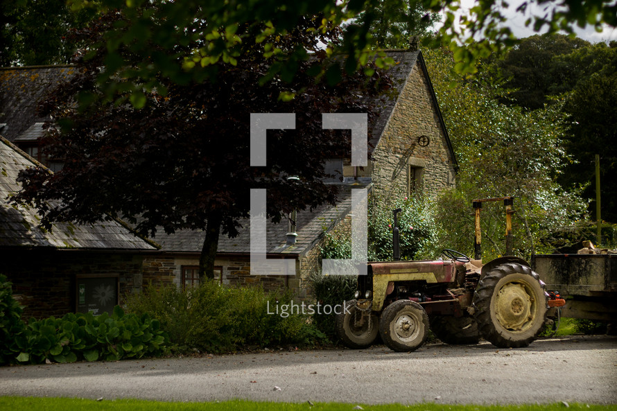 tractor in front of a rural home 