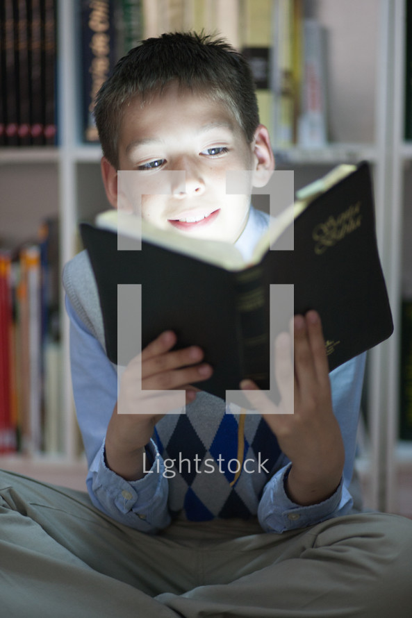 boy reading the Holy Bible