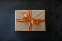 a wrapped present with an orange bow 