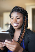african-american woman looking at an iPad screen 