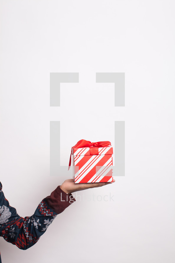 arm holding a wrapped gift 