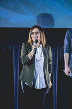 worship leaders on stage holding microphones 