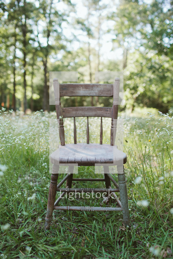 isolated chair in a meadow