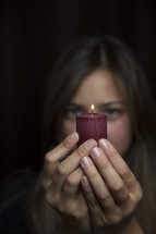 woman holding a red candle 