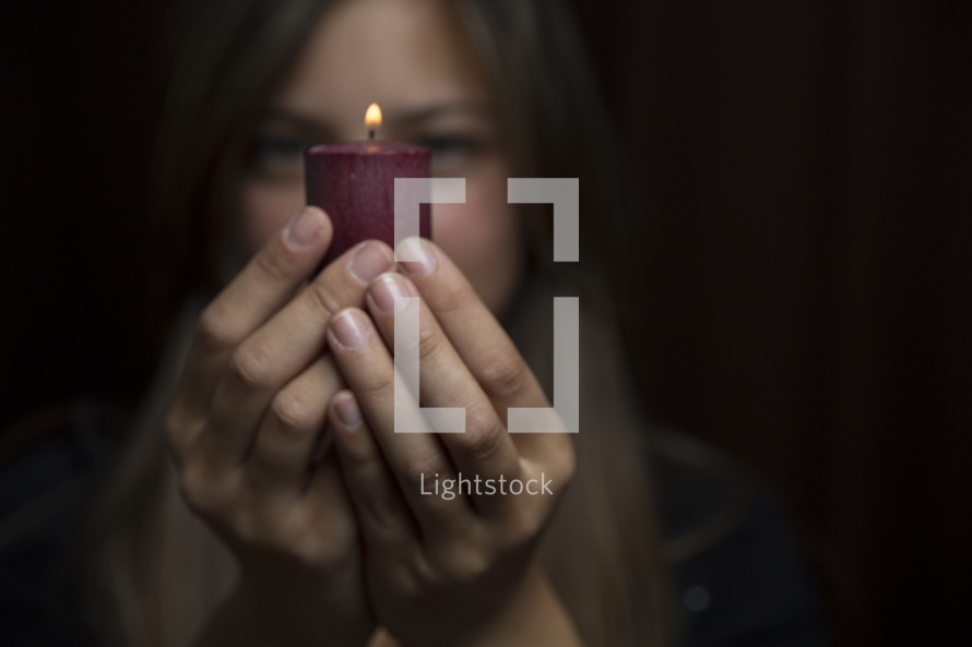 woman holding a burning candle