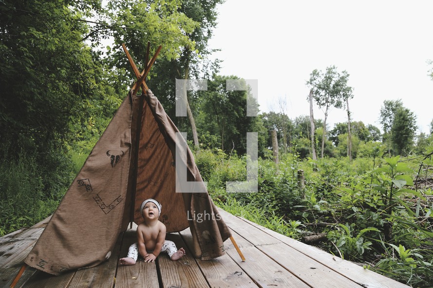 an infant in a teepee