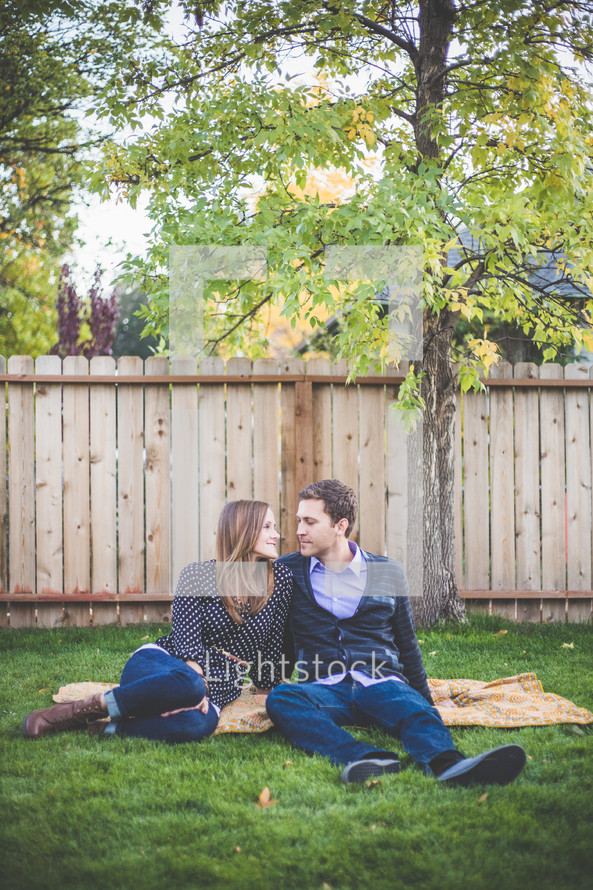 young couple sitting in the grass