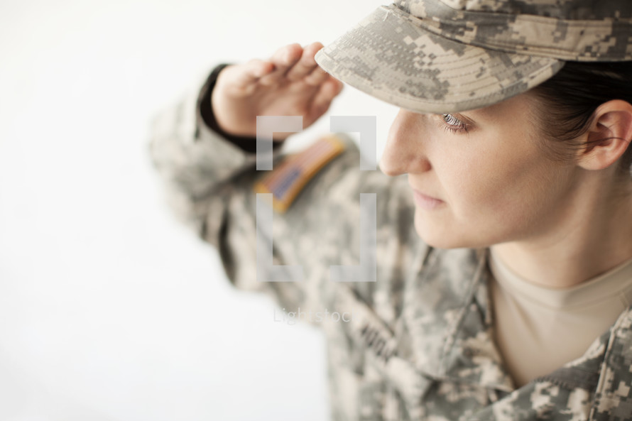 Female soldier in uniform saluting.