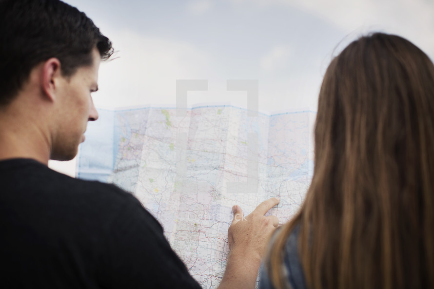 man and woman looking at a map together 