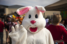 Person in Easter bunny costume at a festival.
