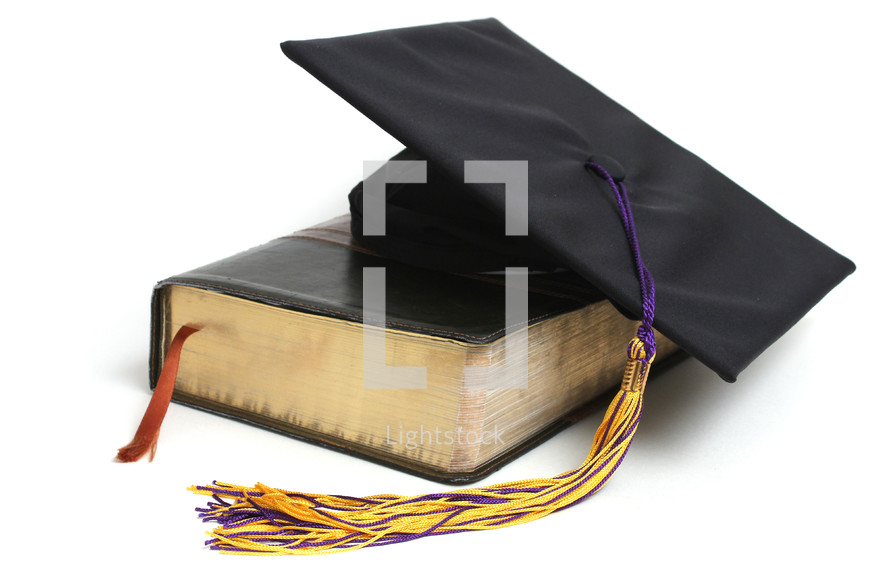 graduation cap and a Bible