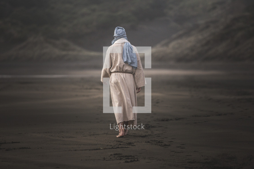  Jesus walking barefoot on a beach 