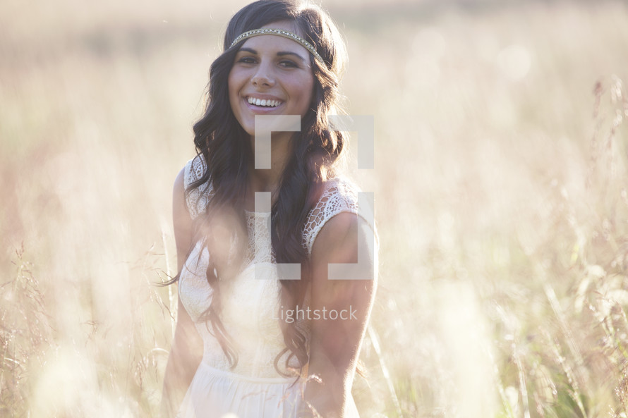 Smiling woman in a wheat field.