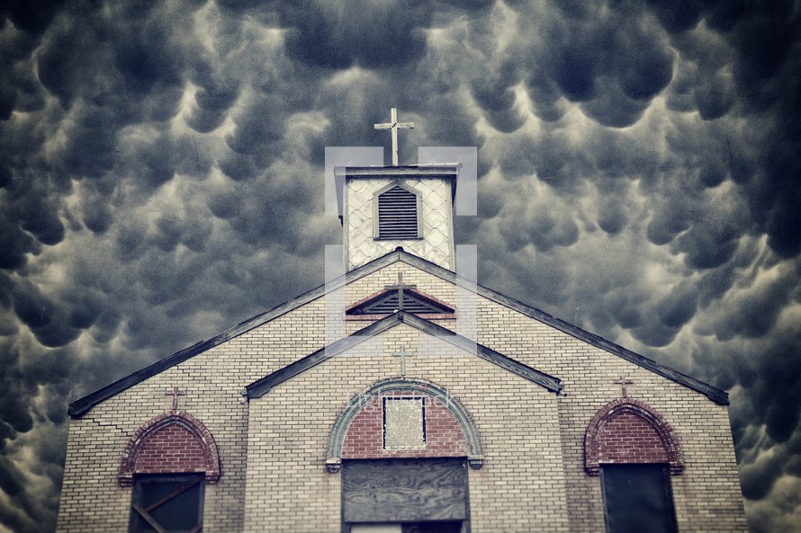 boarded up church under a cloudy sky