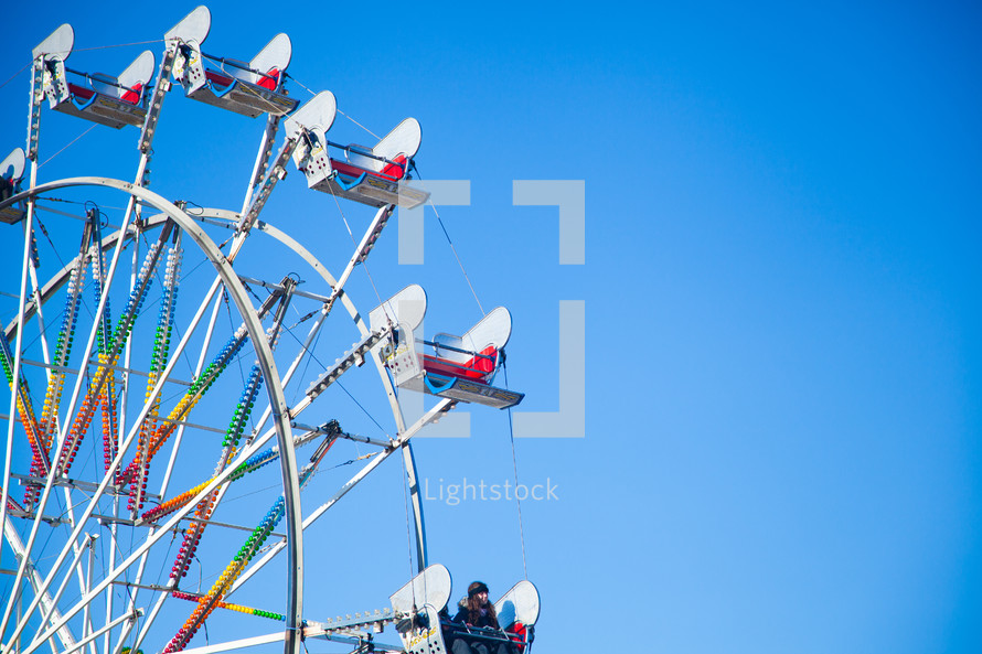A Ferris wheel in a blue sky.