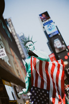 man dressed up like the statue of liberty in Times Square 