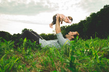Father holding his daughter in the air