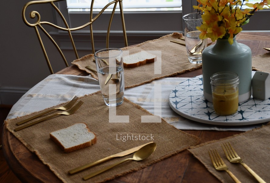 bread and water on a kitchen table 