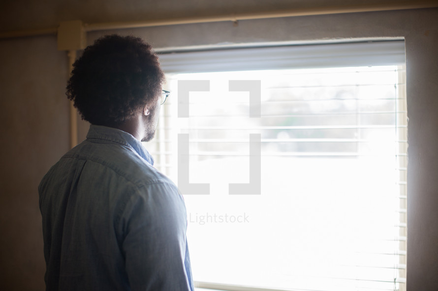 A man looking out a window 