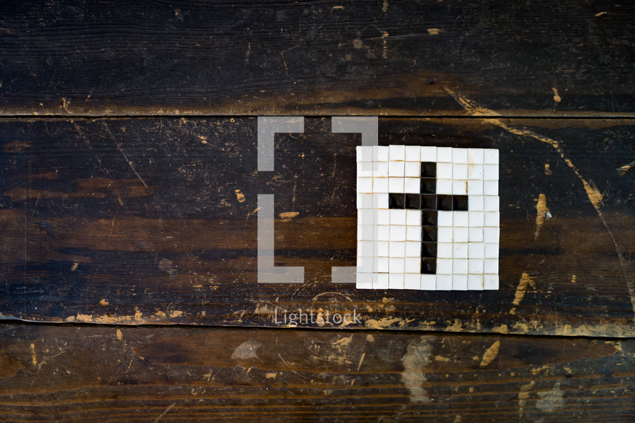cross tile mosaic on a wood floor 
