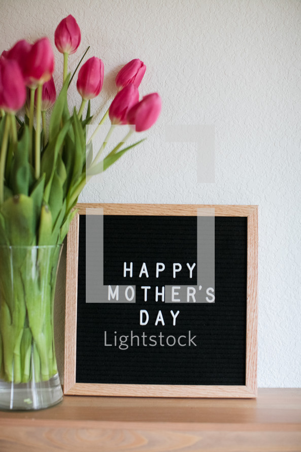 Happy Mother's day sign and tulips in a vase 