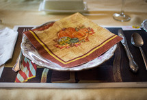 a Thanksgiving napkin on a plate 