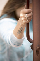 forgiven tattoo on a woman's arm