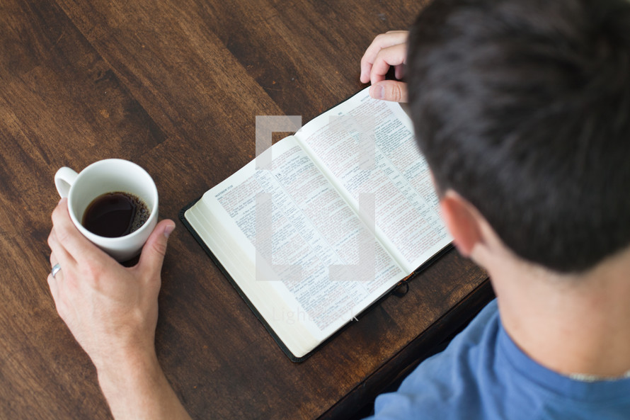 morning devotional - man reading a Bible and a cup of coffee 