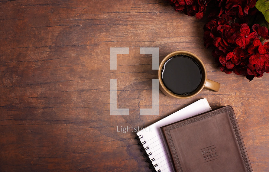 red hydrangeas, Bible, journal, and coffee cup on a wood table 