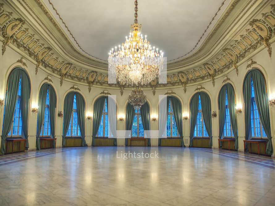 Big castle dancing room with candelabra in th middle. Castle interior. Empty room