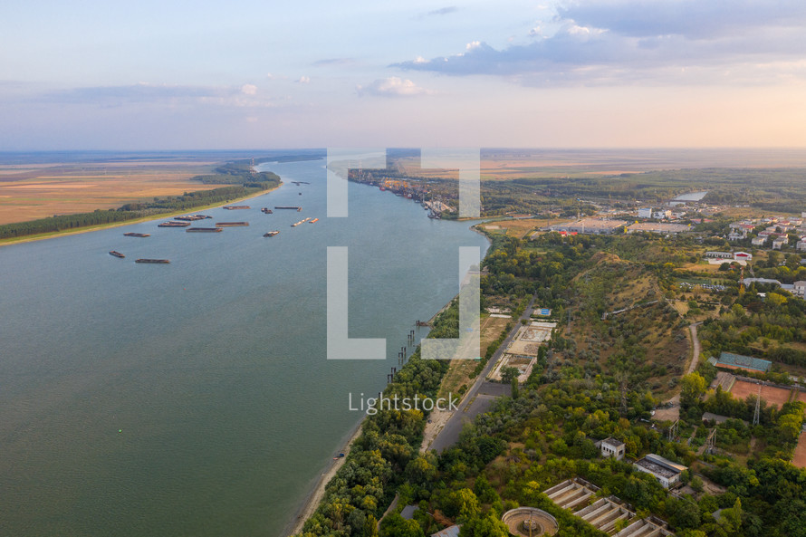 Aerial view of Galati City, Romania. Danube River near city with sunset warm light