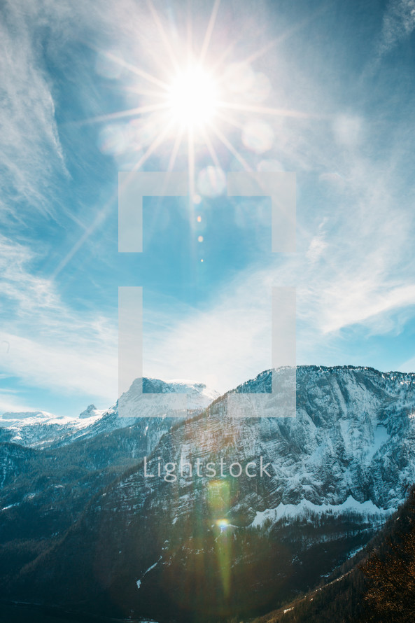 sunburst over snow capped mountains in Austria 