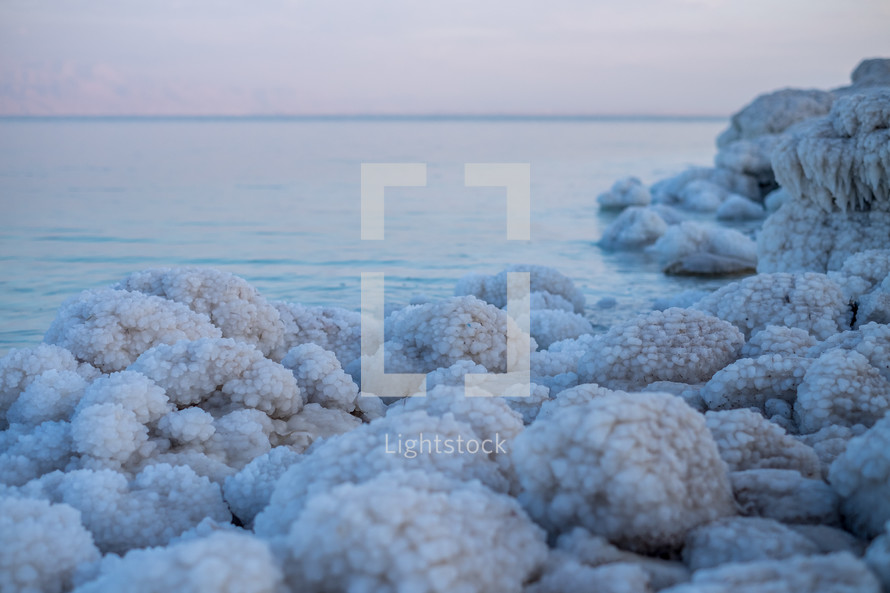 crystalized salt along a shore 