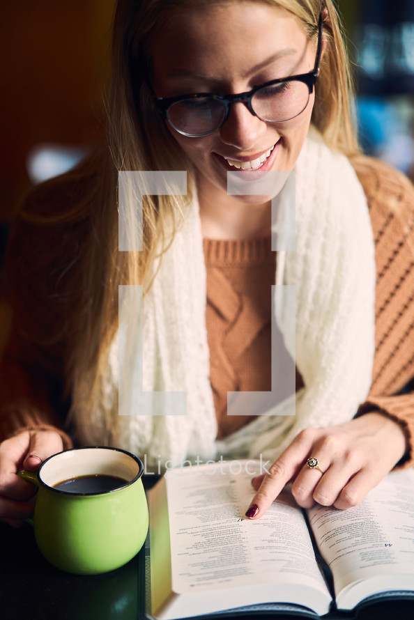 a woman reading a Bible and a coffee cup