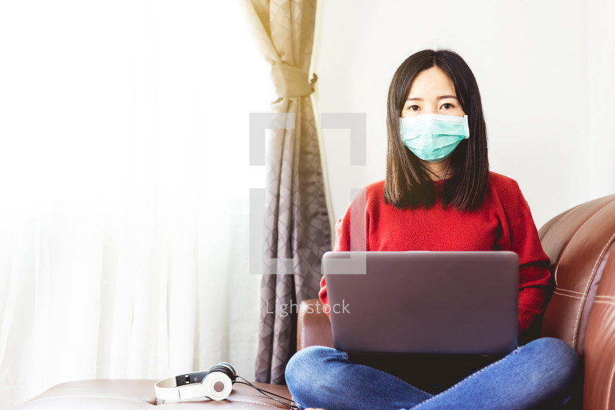 woman working from home wearing a mask 