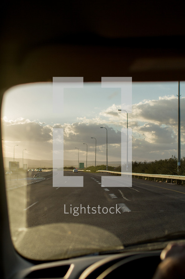 view of the road ahead through a windshield 