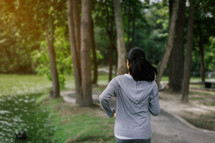 a woman jogging in a park 