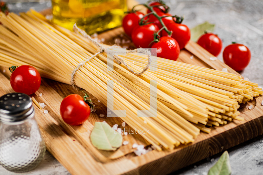 A pile of spaghetti dry on the table. Against a dark background. High quality photo