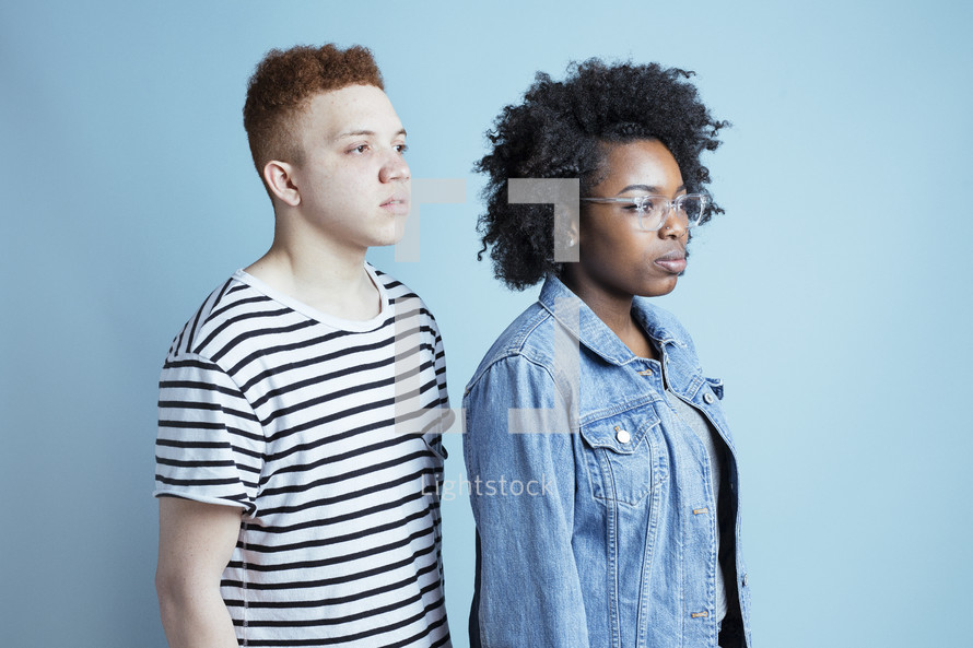 headshot of two young adults staring off into space 