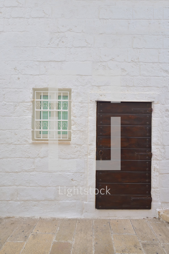 Traditional facade of south adriatic sea house with door and window minimalist decorated in small village of Monopoli, south Italy