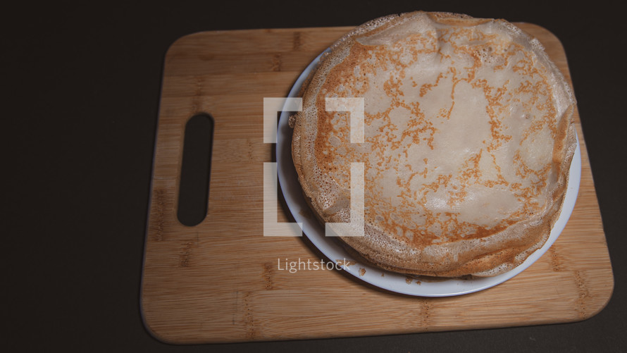 Top view of thin pancake on black background and copy space
