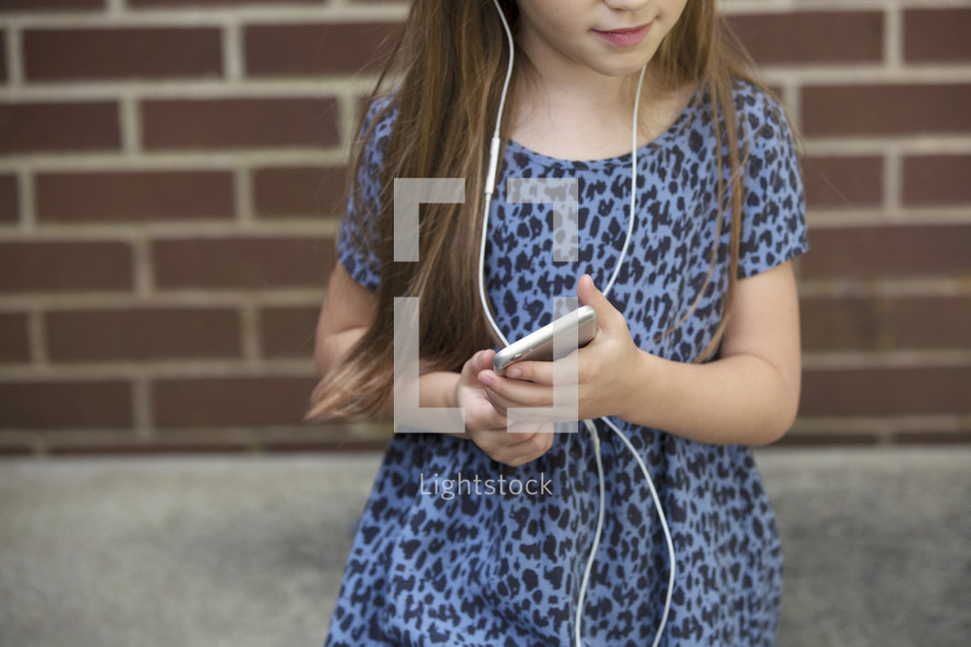 a little girl listening to music 