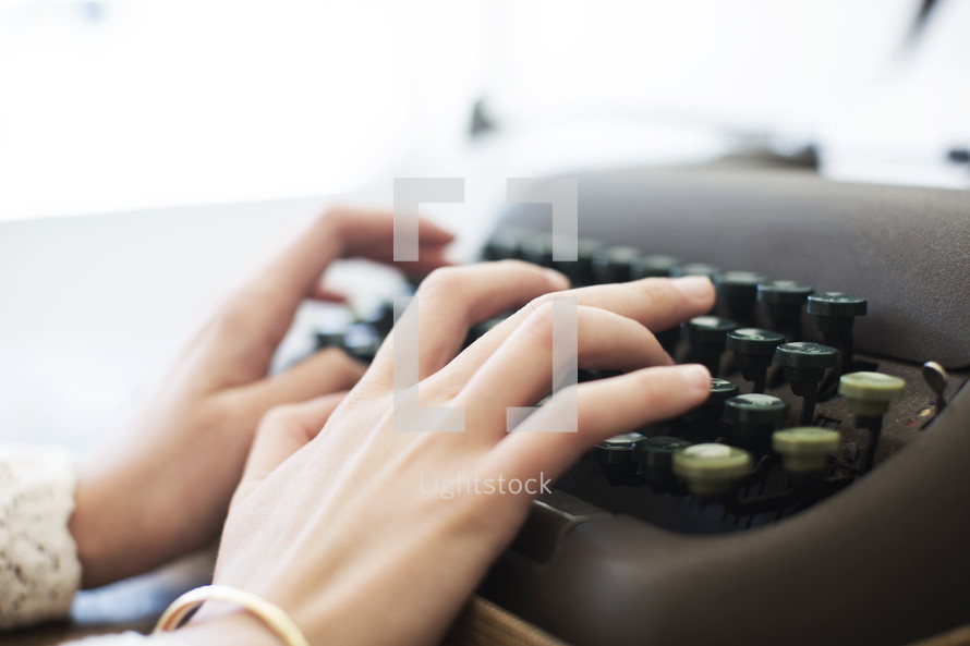 woman typing on a type writer 