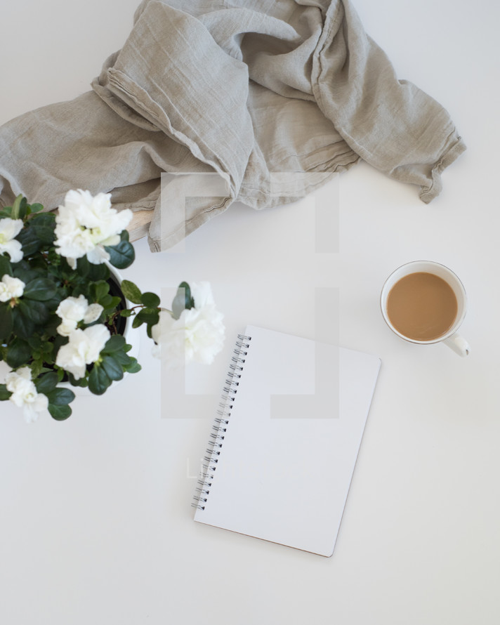 flowers, notebook, linen fabric, and coffee mug 