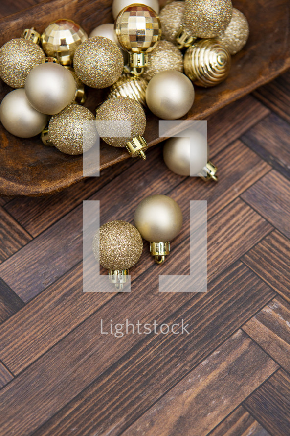 Gold Christmas ornaments on wooden table