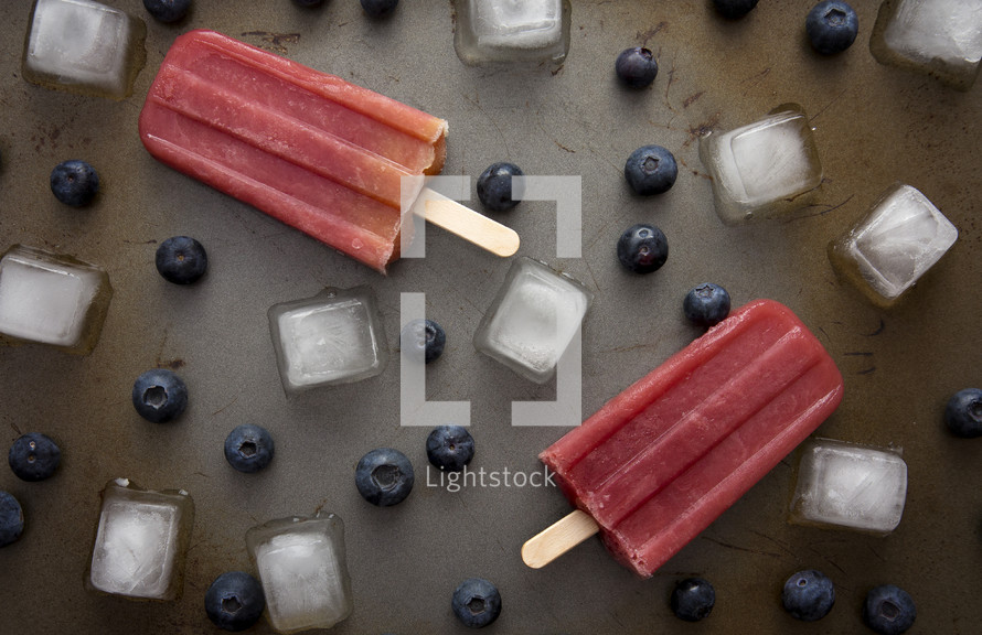 Frozen Homeamde Blueberry Popsicles on a tray