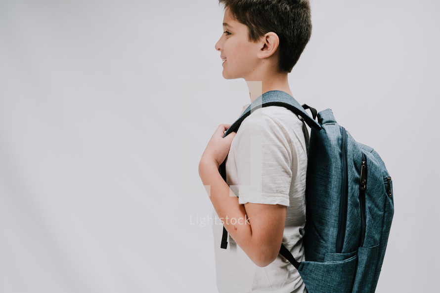 a boy with a book bag 