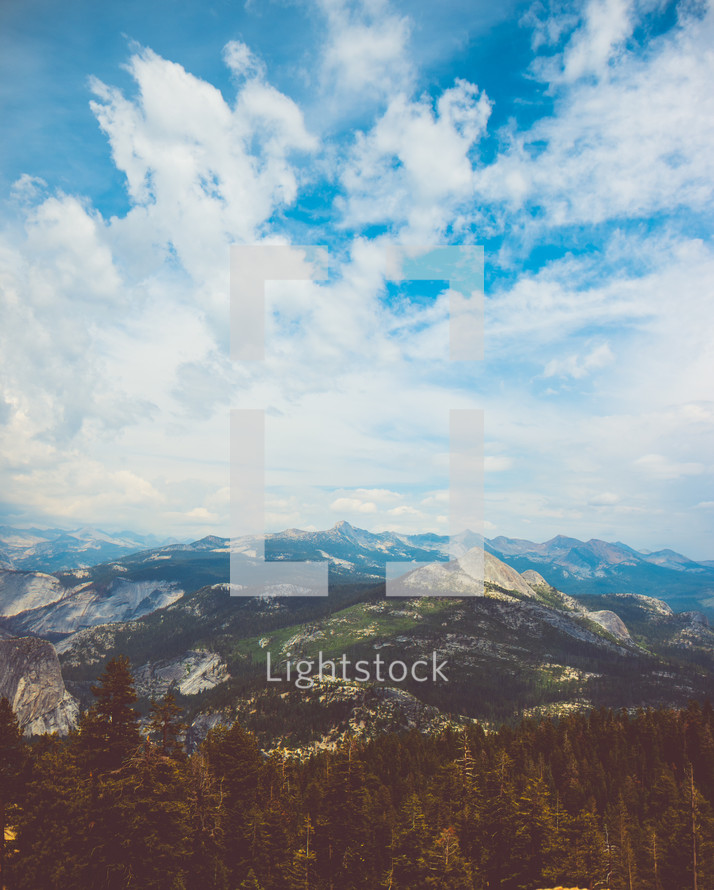 Clouds above mountain peaks outdoors | Skyline | Landscape | Nature | Background | Trees | Sky | Light | Day | Glory