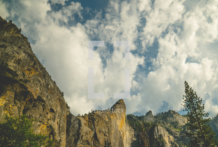 Clouds above mountain peaks | Nature | Landscape | Trees | Glory | Majestic | Journey | Sky | Light | Summer | Cliffs | Rocks | Retreat | Camp | Background