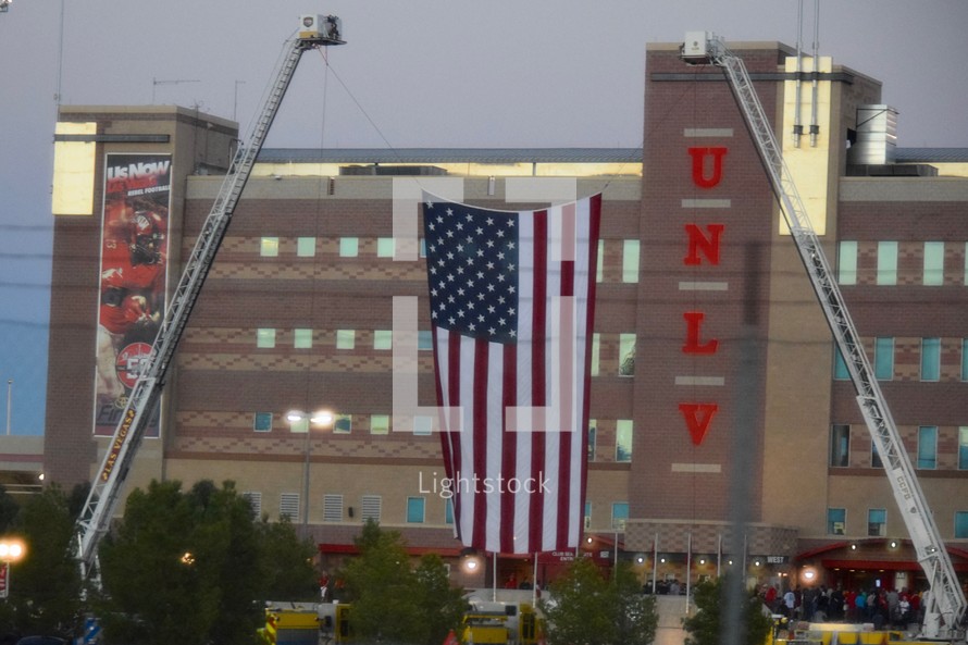 American flag hanging between two fire trucks in front of Sam Boyd Stadium to honor the first responders and victims of the Las Vegas Mass Shooting 